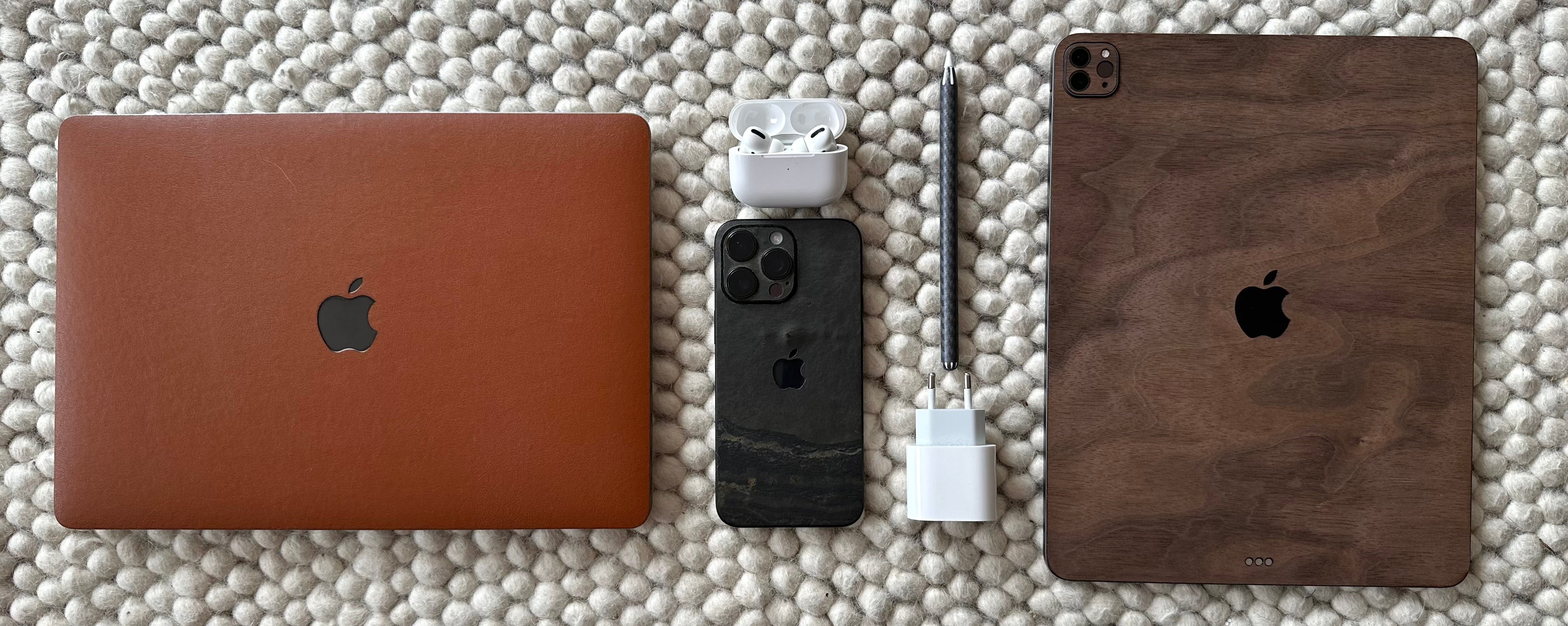 iPad with wood skin, MacBook with leather skin, iPhone with stone skin
